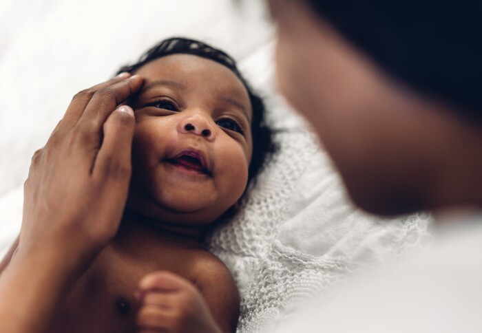 Photo of baby smiling at parent