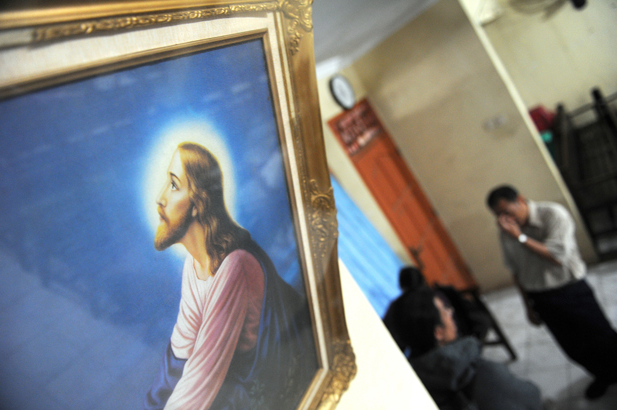 Indonesia authorities close down church; pastor dragged