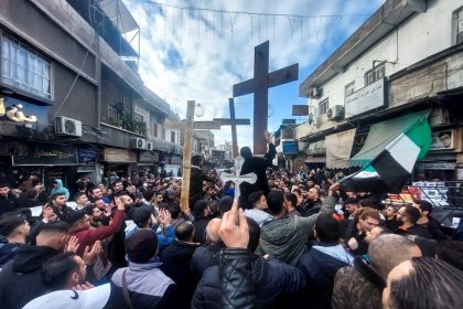 Christians protest in Syria after Christmas tree set on fire