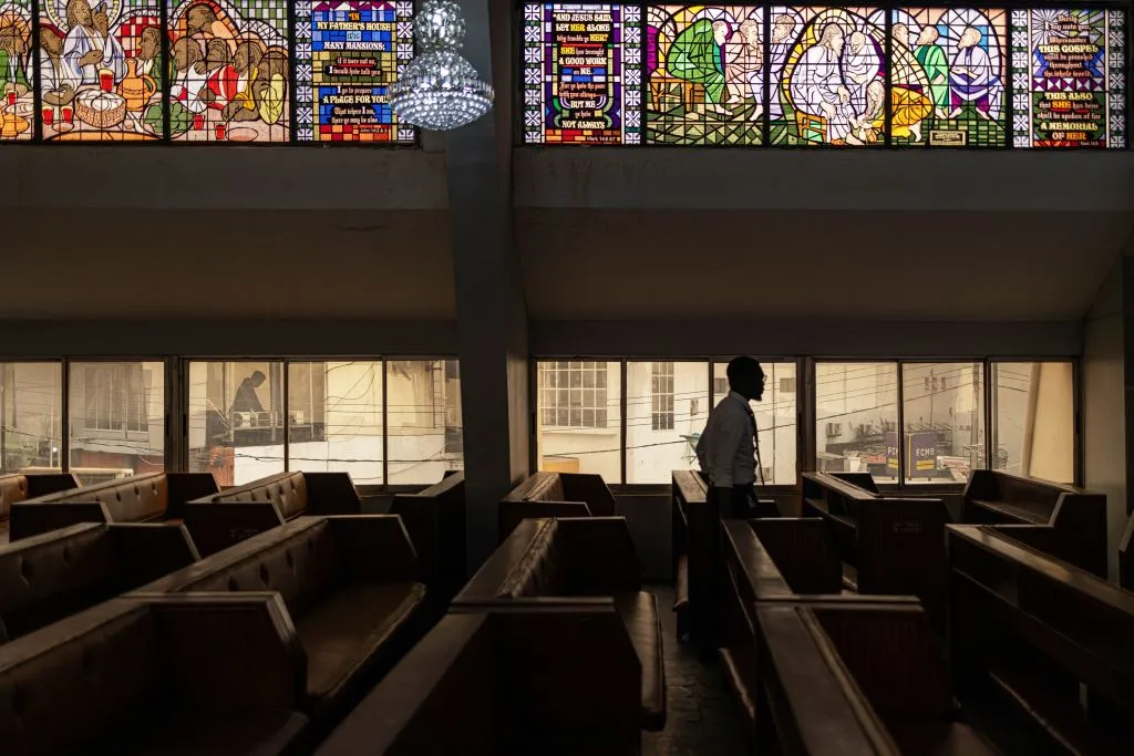 A man walks through the bench of the Methodist Church of the Trinity in Lagos on February 19, 2023 (Getty)