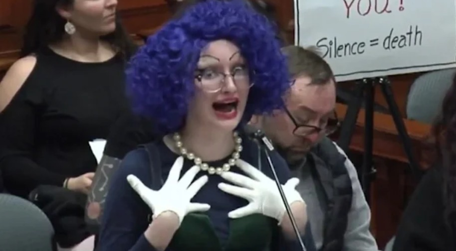 Lesbian pastor blasphemes Jesus as drag queen at council meeting