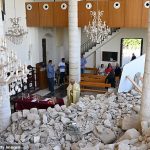 Christians attend the Easter mass at the Saint George Melkite Greek Catholic Church, which was almost completely destroyed by Israeli airstrikes, in the town of Derdghaya, Tyre, Lebanon on April 20, 2025
