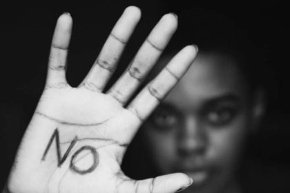 Closeup of girls hand with the word no