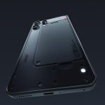 Dramatic view of the Nothing Phone 3a Lite smartphone. Its notification LED is lit, as the black phone floats against a dark background.