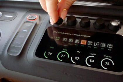 A hand adjusting knobs on the JBL BandBox Trio speaker